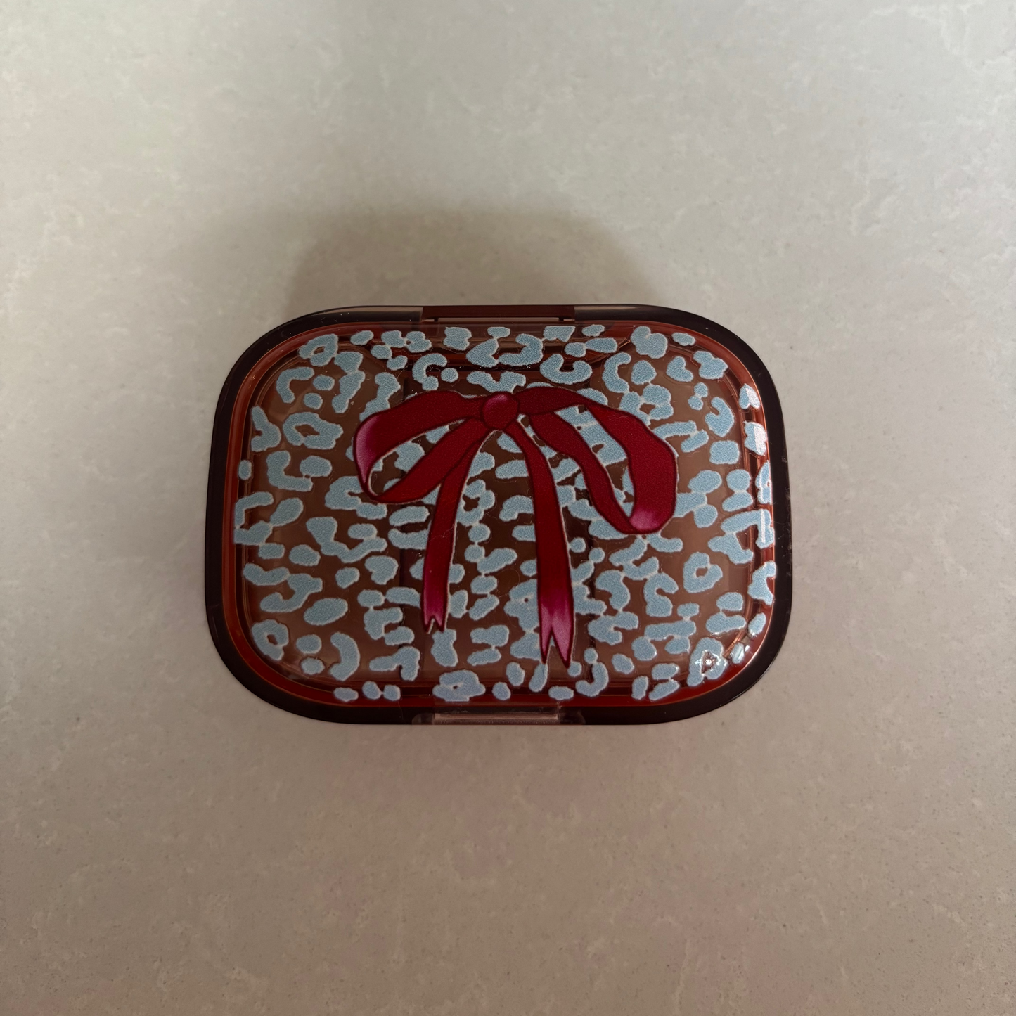 Ice Blue Leopard with Burgundy Bow on Peach Pill Pot